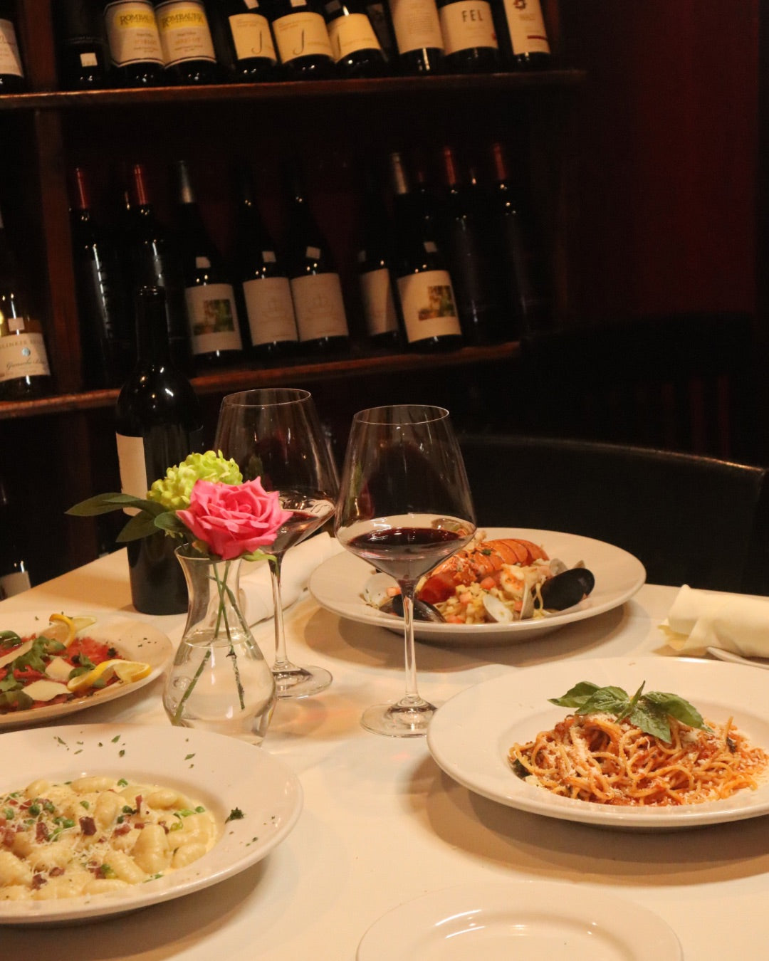 A romantic table Set with Italian Pastas placed on a table with white table cloth inside Anacapris private wine room. 